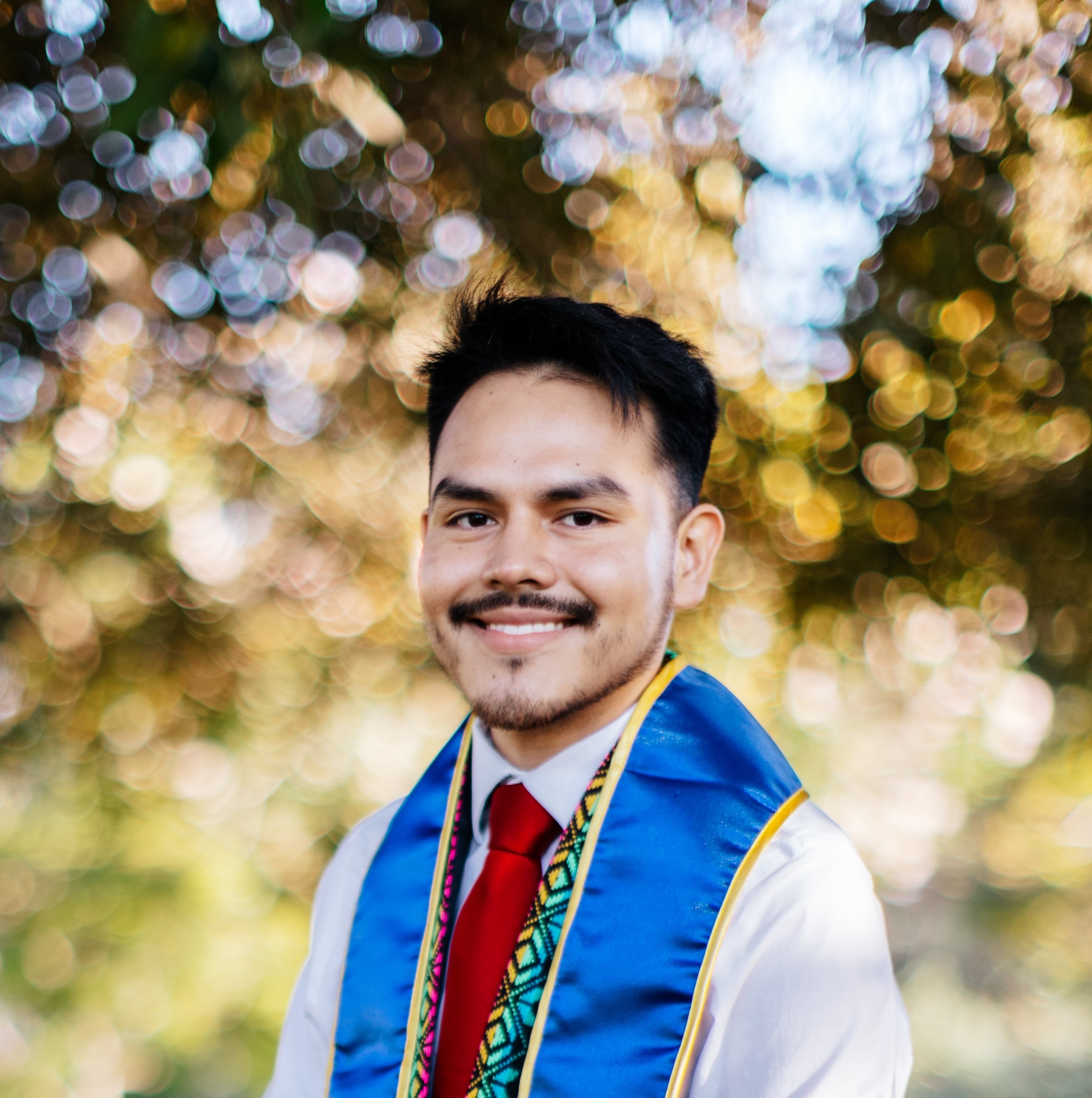 Picture of Luis Espino with UCI graduation stole